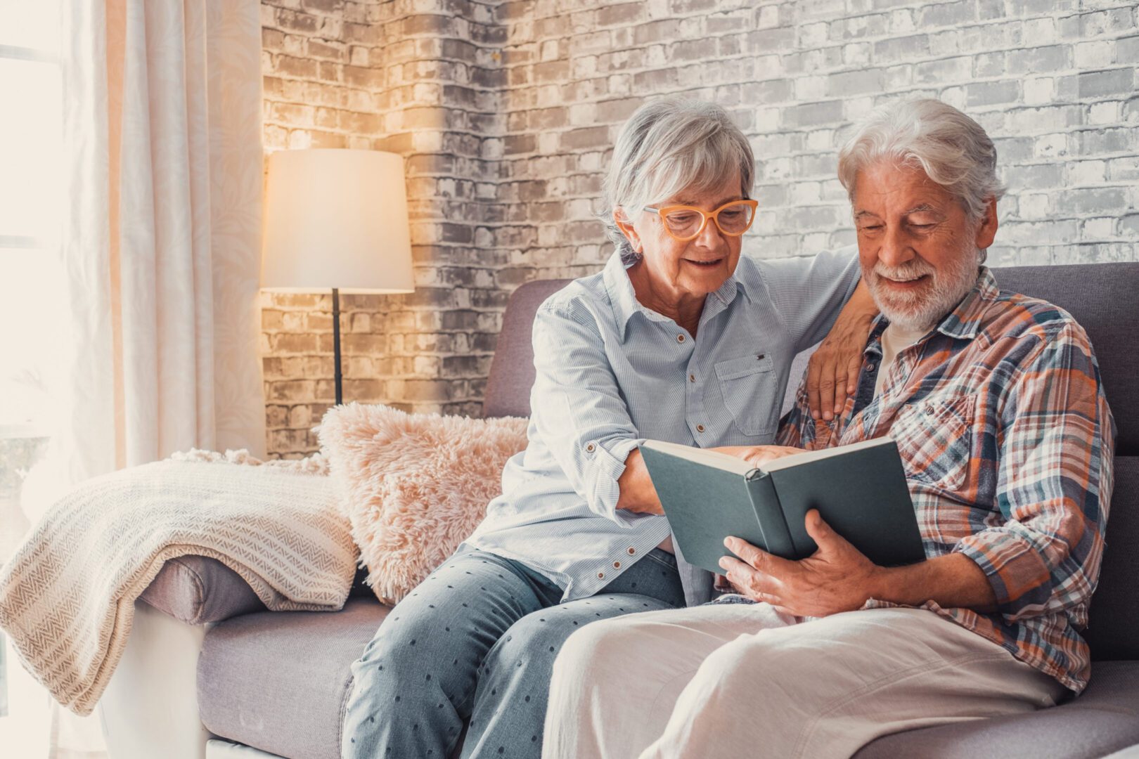 Happy older couple relaxing with a book
